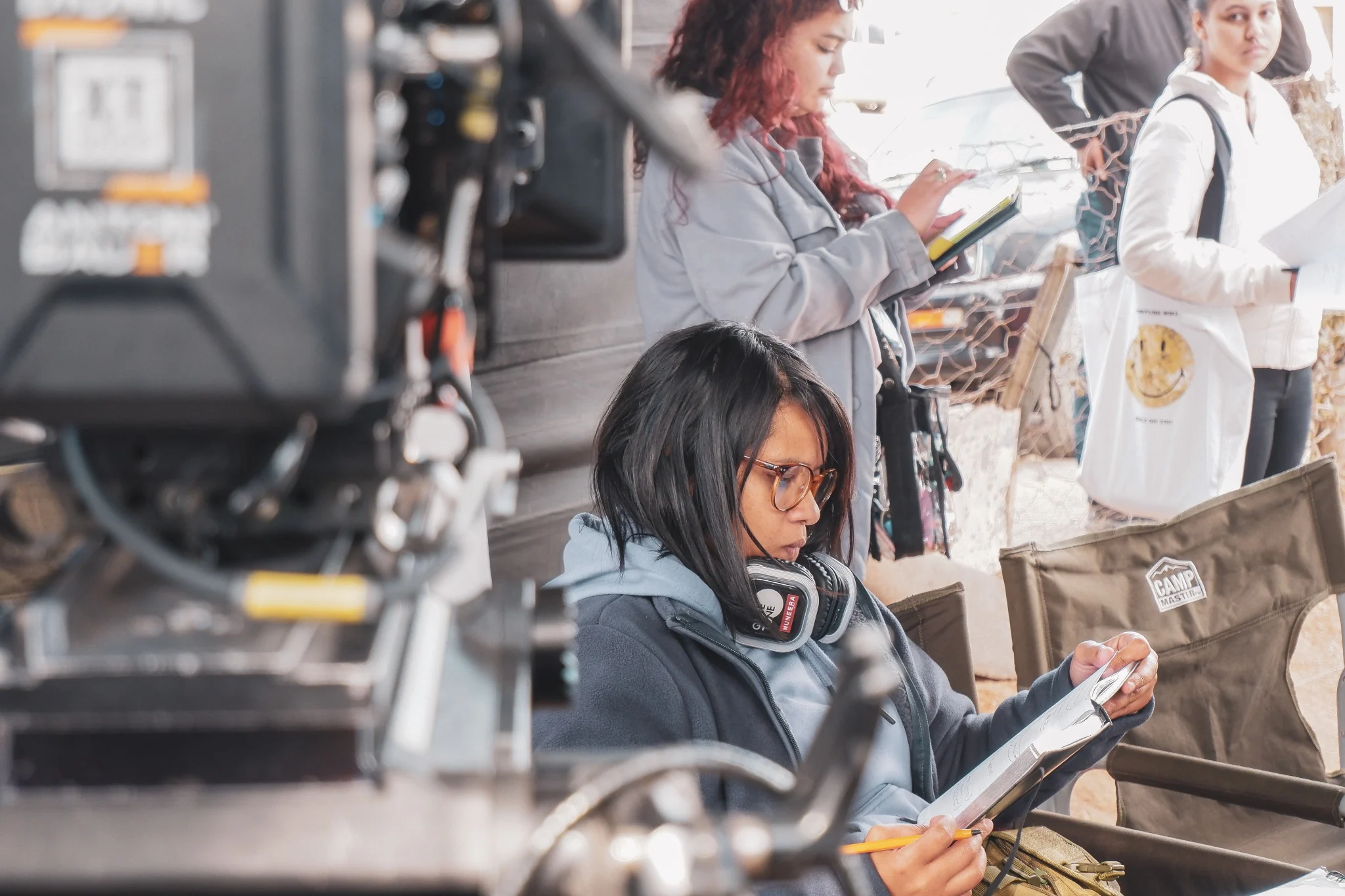 Muneera Sallies reviewing a script beside the cinema camera